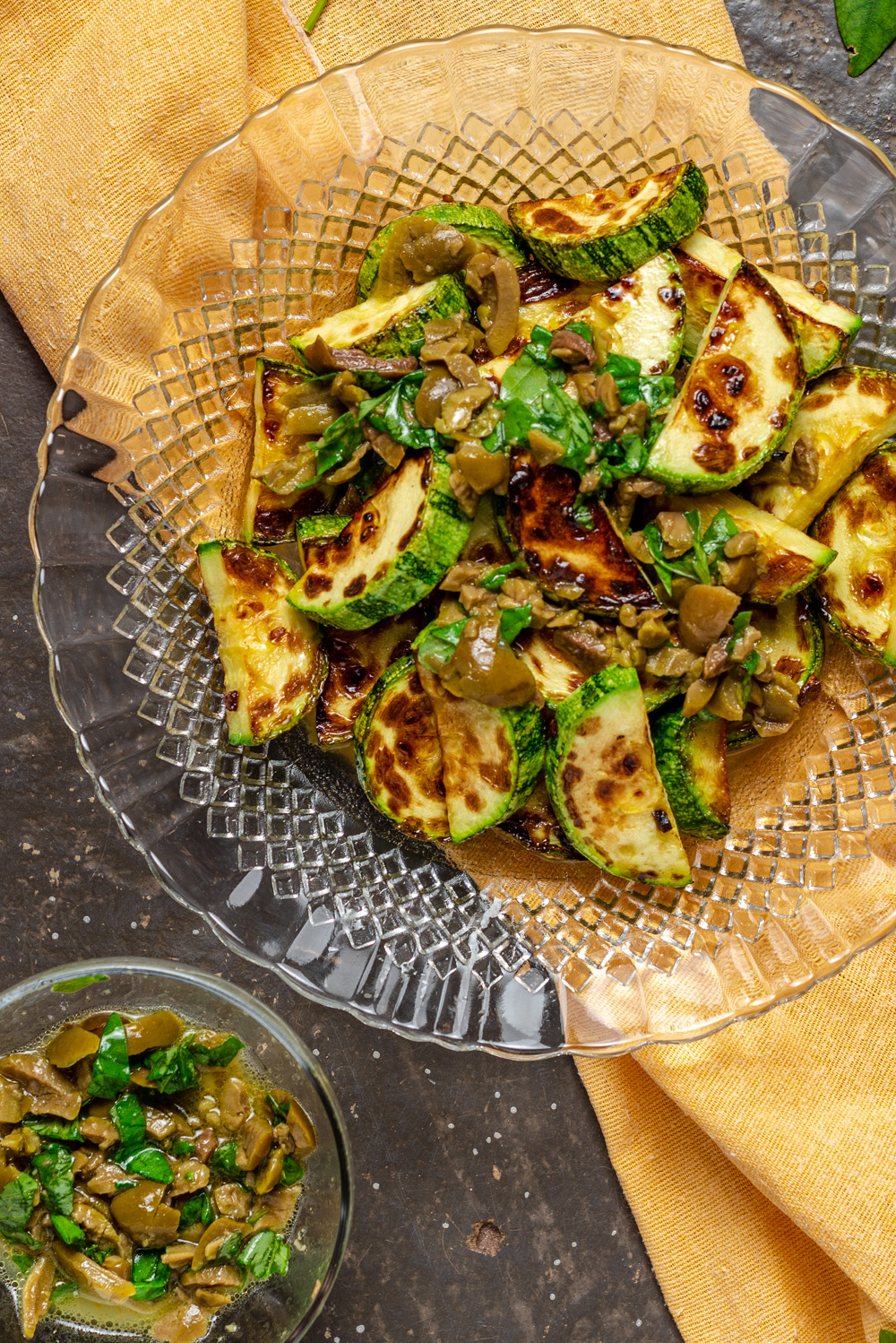 plate of sauteed zucchini with olives sauce