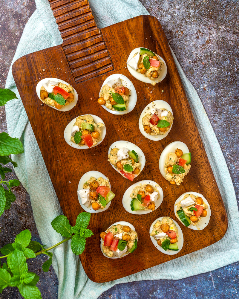 chickpea deviled eggs on a wooden board