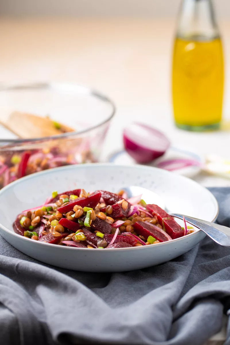 table with a bowl of beetroot and lentil salad
