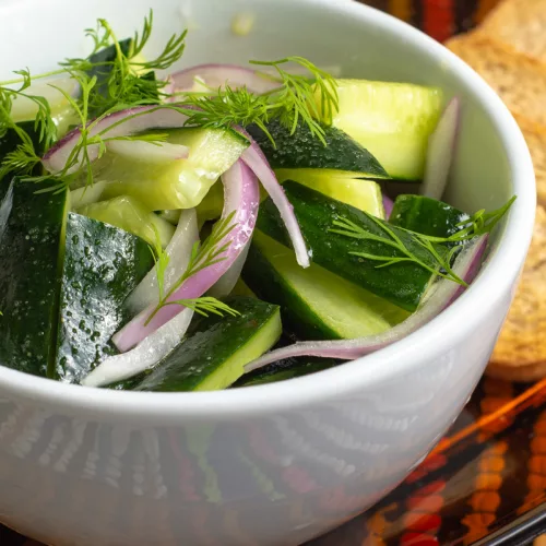 cucumber and dill salad on a bowl