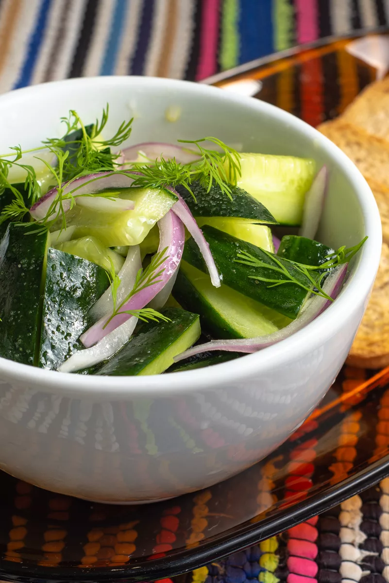 cucumber and dill salad on a bowl