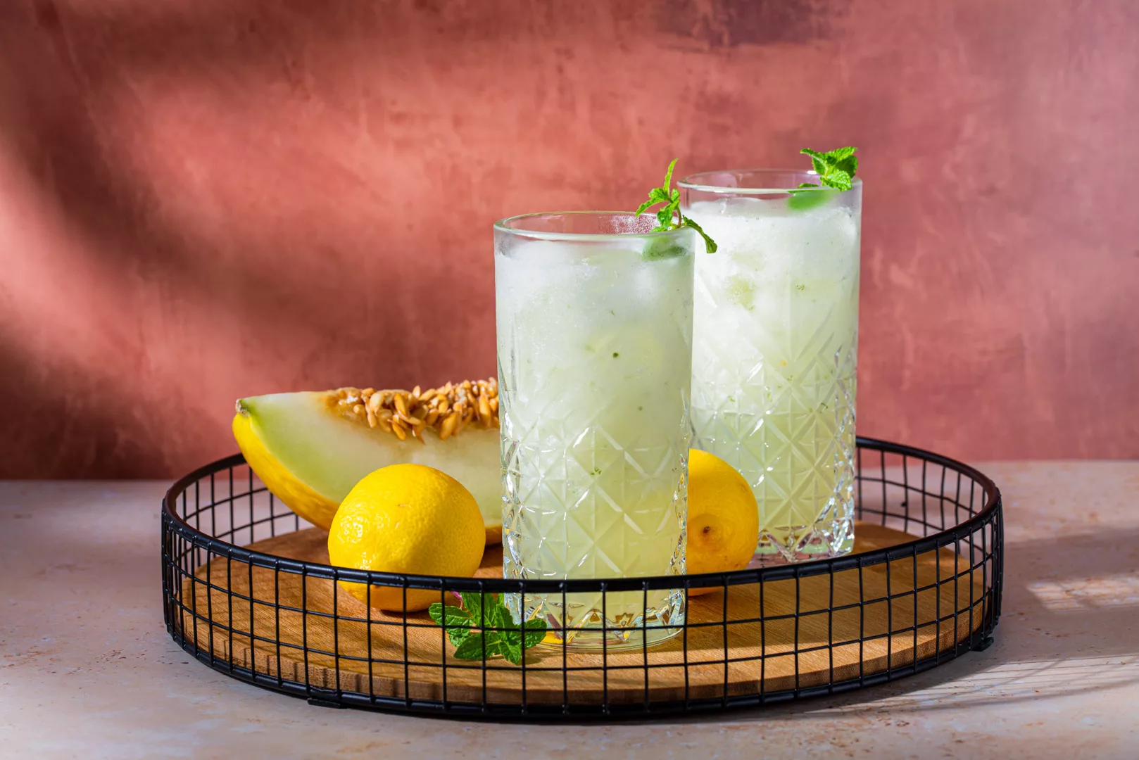 basket with glasses of cantaloupe and lemon juice