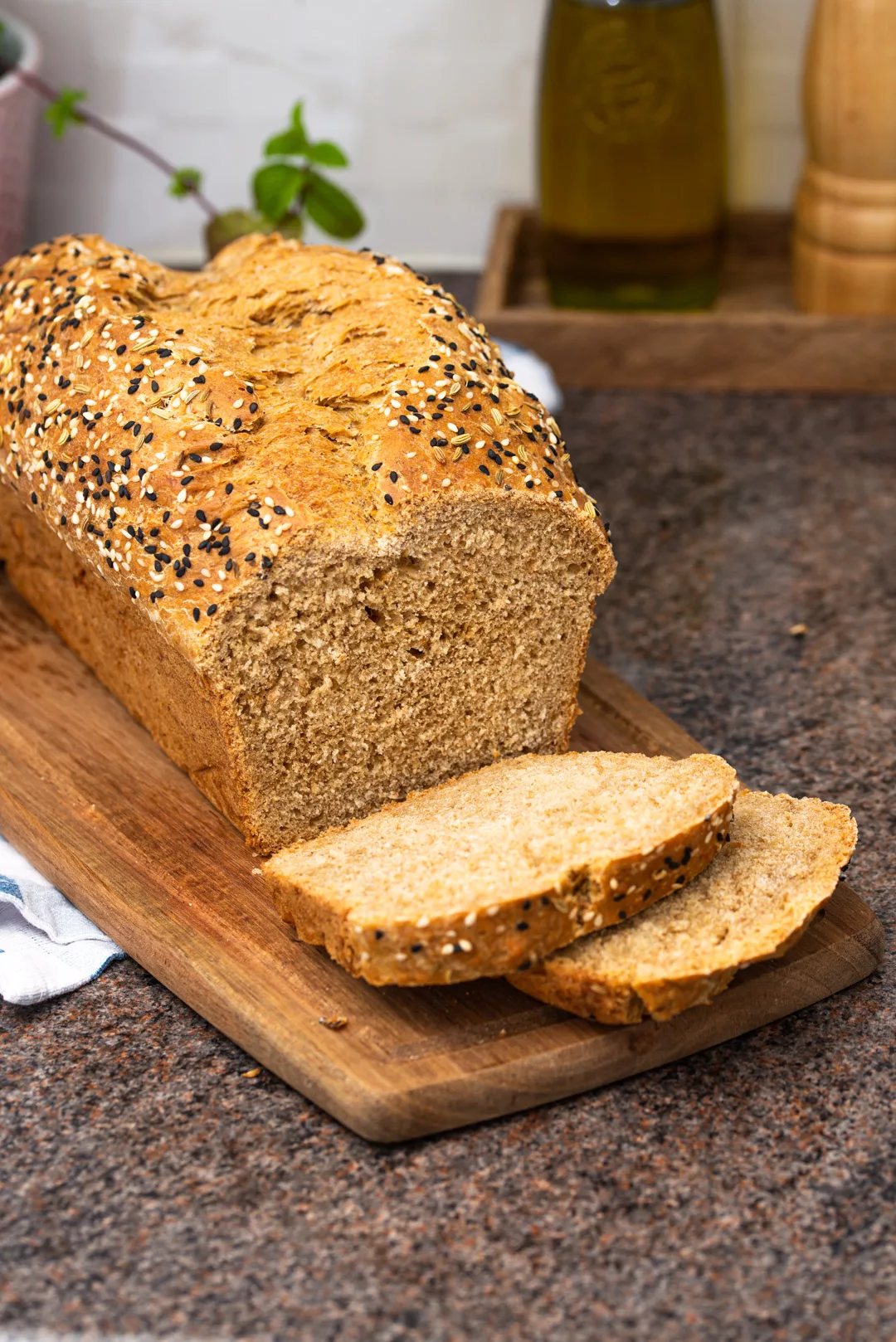 seeded wholemeal bread, sliced on a wooden table