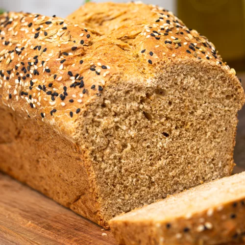 seeded wholemeal bread, sliced on a wooden table