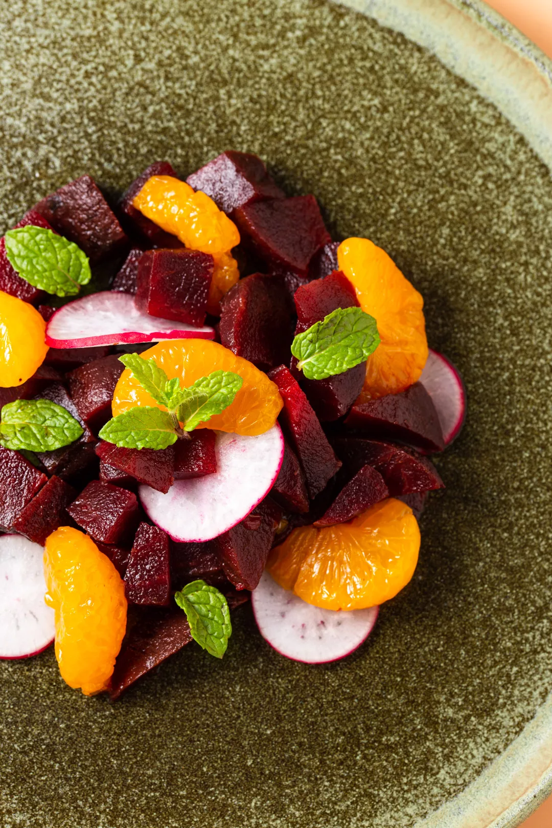 close up shot of beet and orange salad on a plate