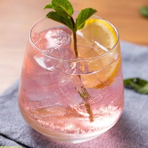 a pink whitney drink with mint and lemon round