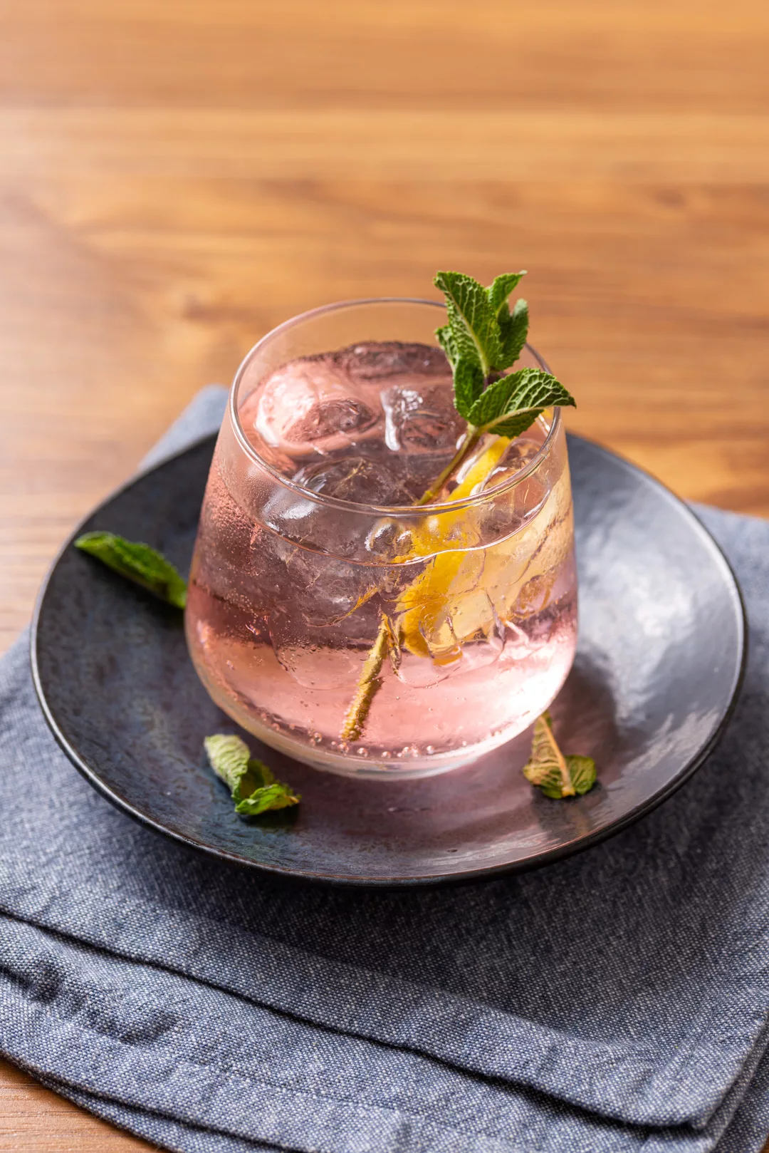 a pink whitney drink with mint and lemon round