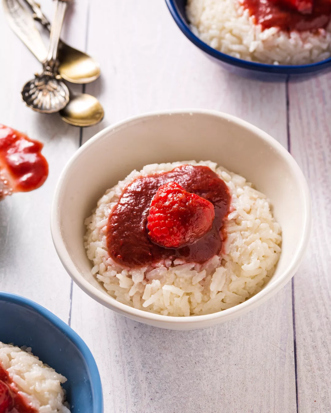 rice pudding with raspberry sauce on a dessert dish
