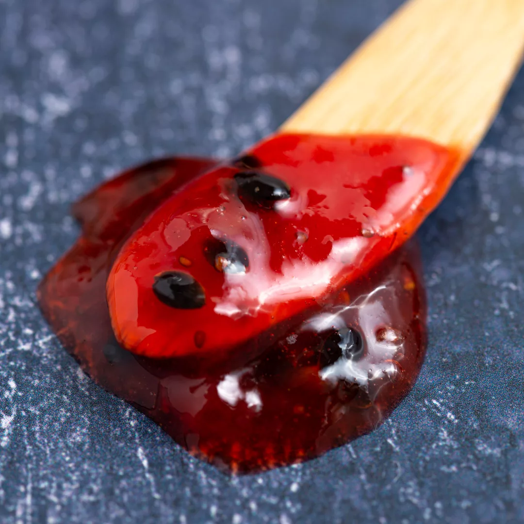 strawberry and passion fruit jam on a spoon