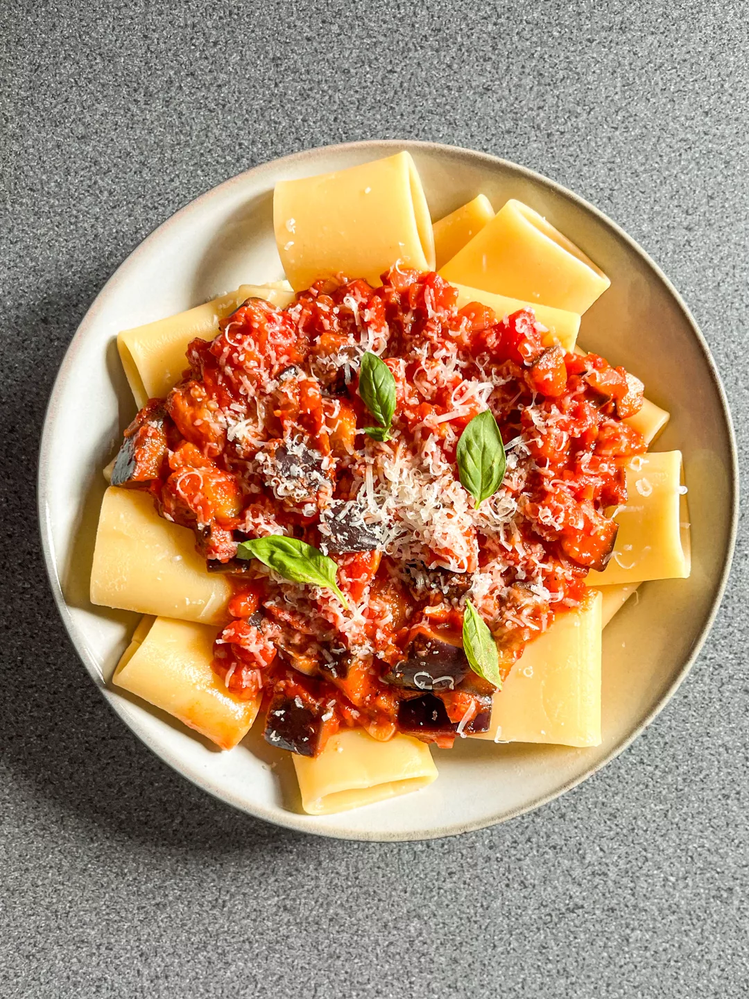 top view of a bowl of paccheri pasta with eggplant and tomato sauce