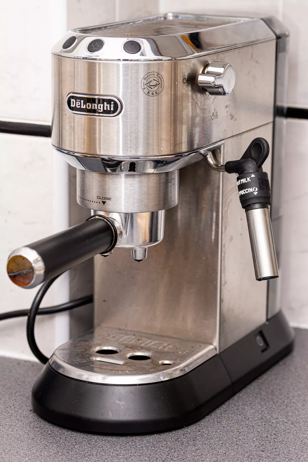 photo of a delonghi dedica espresso machine on a kitchen countertop
